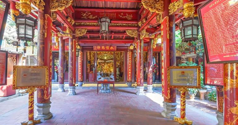 Bach Ma Temple characterized by wooden structures, elaborate carvings, and vibrant colors.