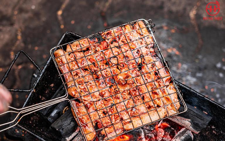 Grill or broil the pork until it is cooked through and slightly charred.