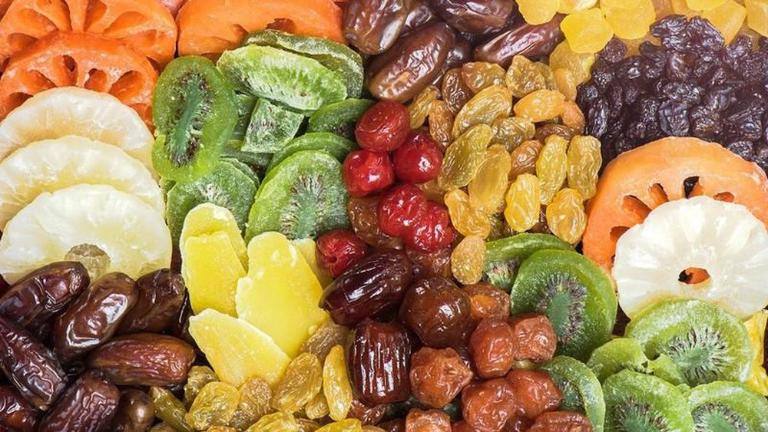 Many stalls at Dong Xuan Market sell packages of dried fruits like jackfruit, mango, and banana.