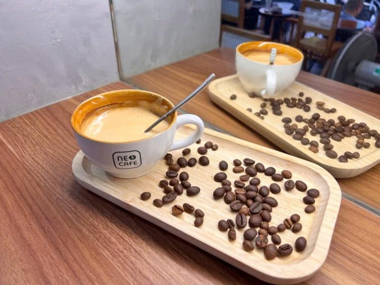 The coffee is typically served in a glass or ceramic cup, often with a layer of foam on top.