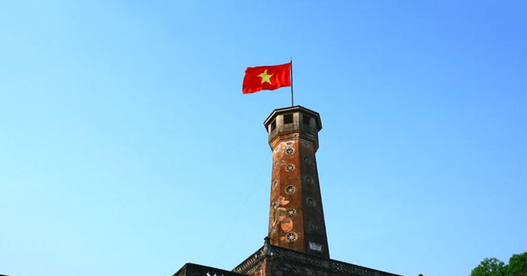 The flag flying at the top of the tower – the red flag with a golden star – is a key symbol