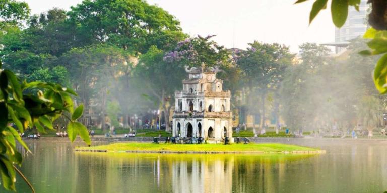 At the heart of Hanoi lies Hoan Kiem Lake, a peaceful body of water surrounded by leafy trees