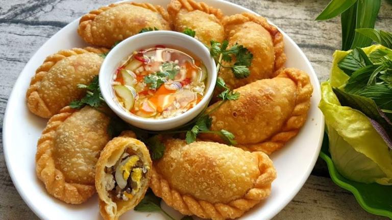 Banh goi is a crispy fried dumpling filled with pork, vermicelli, mushrooms, and quail eggs.