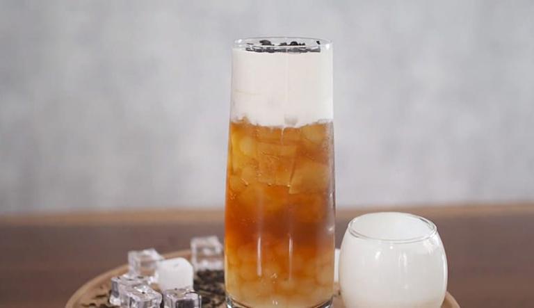 Macchiato Milk Tea layers thick, salted cream foam atop the sweet tea foundation