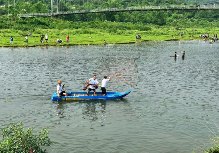 Catching fish by hand in the clear streams of Du Gia offers a thrilling, immersive experience.