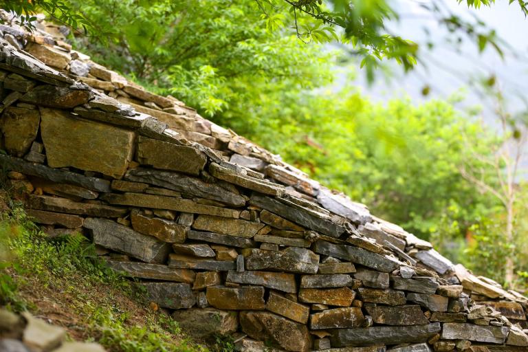 Each stone fence, typical of the highland ethnic people, showcases unique craftsmanship