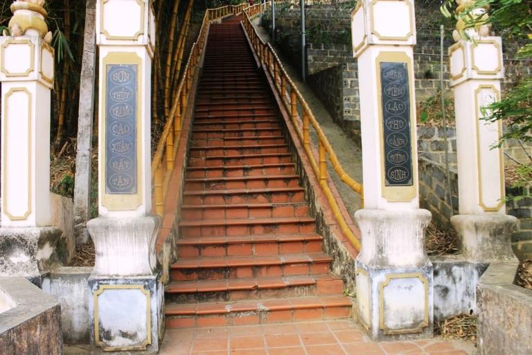 The gates are adorned with intricate Buddhist motifs on stone pillars