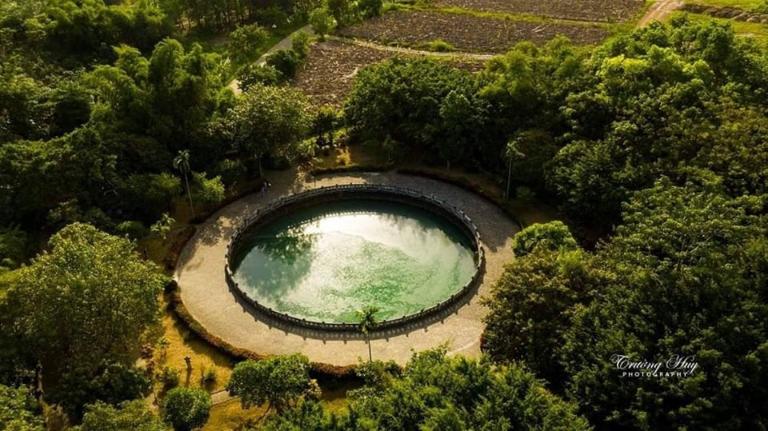 An ancient well with emerald-green water, believed to have healing properties.