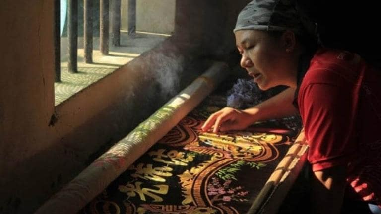 Explore the embroidery craft village of Van Lam and witness skilled artisans creating intricate embroidery designs.