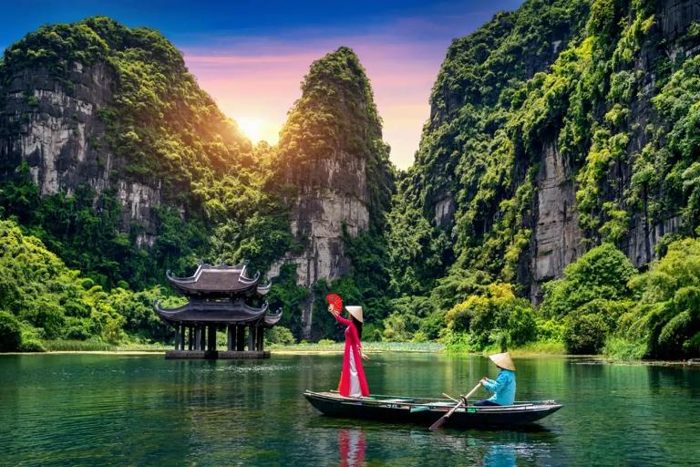 Visit Trang An to cruise through serene waterways and explore caves and ancient temples in a UNESCO site.