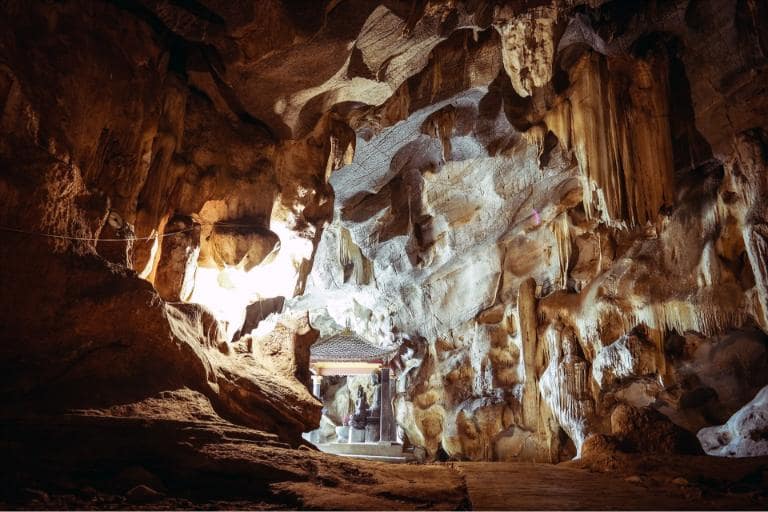 Bright Cave dazzles with sunlight and diamond-like stalactites, a shining refuge for visitors.