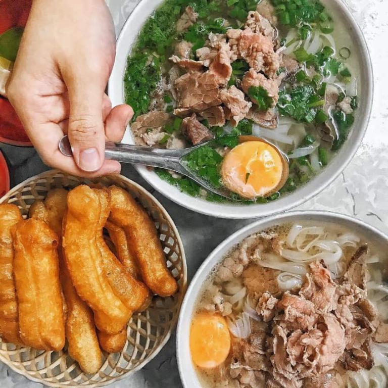 Enjoy a bowl of Hanoi’s famous Pho, a delicious mix of fresh herbs, tender beef, and rich broth