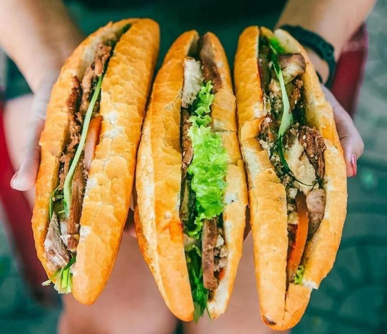 Try the iconic Banh Mi, a crispy baguette filled with savory meats, fresh vegetables, and sauce