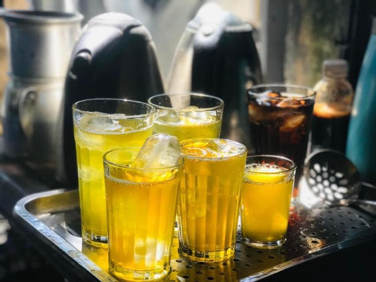 Enjoy the perfect combination of sunflower seeds and iced tea, a popular, refreshing street snack in Hanoi.