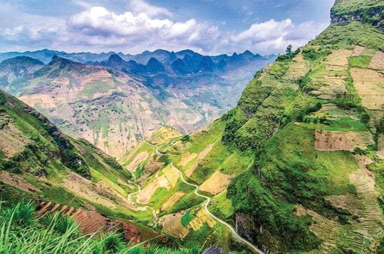 Stretching through rugged mountains, Happiness Road symbolizes unity and sacrifice in Ha Giang.