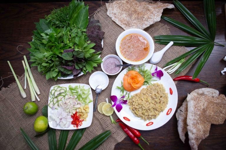 Key ingredients include fresh nhech fish, roasted rice powder, and fragrant herbs.