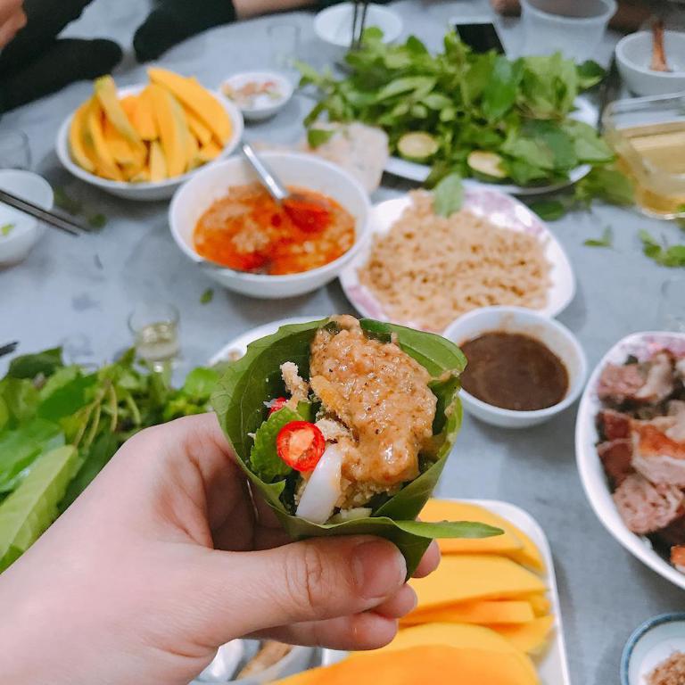 Roll the fish tightly with herbs in rice paper to ensure a perfect mix in every bite.