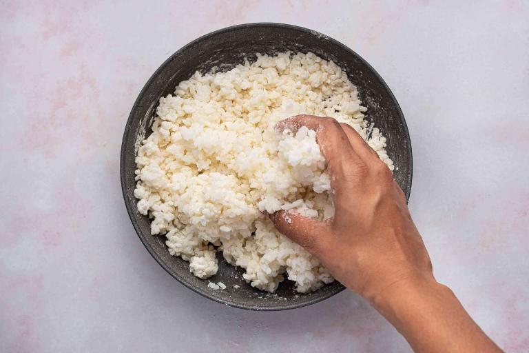 Making crispy rice at home is simple: cook rice, press it flat, dry it, then fry until golden and crunchy.