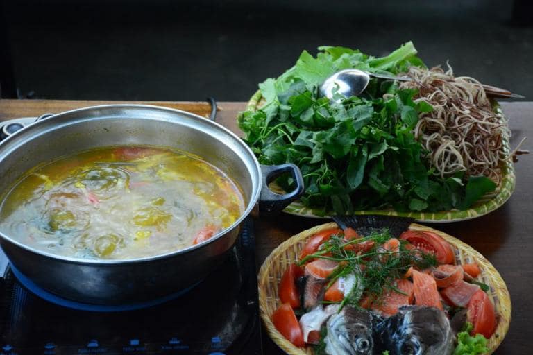 Tomatoes, dill, and local spices create a vibrant broth for Salmon Hotpot, a truly social dish.