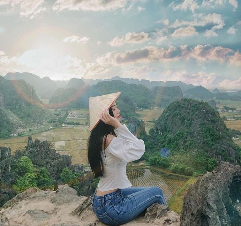 Snap photos at Tam Coc pier, surrounded by scenic limestone hills and tranquil river views.