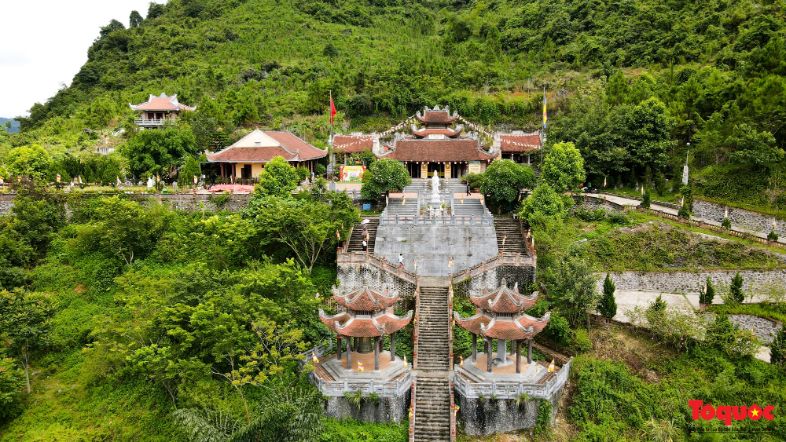 Trúc Lâm Pagoda in Vietnam, featuring traditional architecture surrounded by lush forested hills and mist.