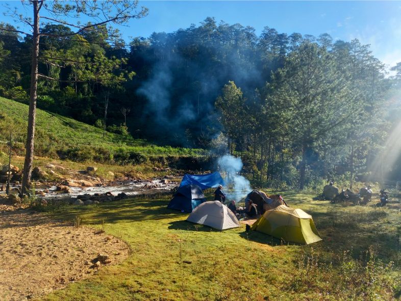 A camper comparing tents designed for tropical humidity and temperate cooler conditions in Vietnam.