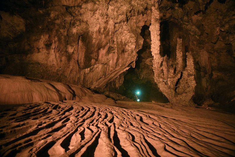 Limestone stalactites and stalagmites inside Nguom Ngao Cave, formed naturally over millions of years by flowing water.