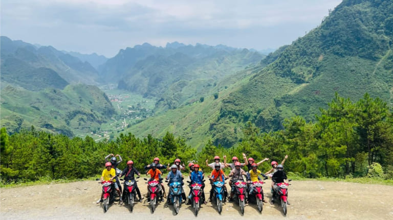 Winding mountain roads cut through towering limestone peaks, setting the stage for an unforgettable Ha Giang Loop adventure.