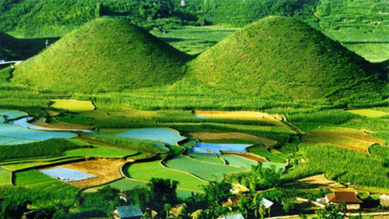 Twin Mountains rises peacefully from the lush green valley below.