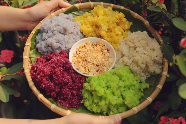 Five-colored sticky rice made with natural plant dyes, a traditional Hmong dish symbolizing harmony and prosperity in Ha Giang.