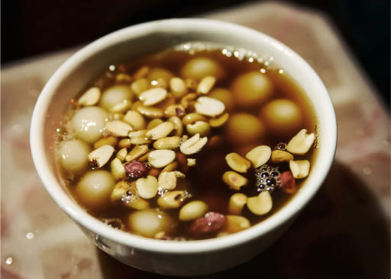 Traditional Thang Den black pudding, a chewy and savory local delicacy made from sticky rice and buffalo blood.