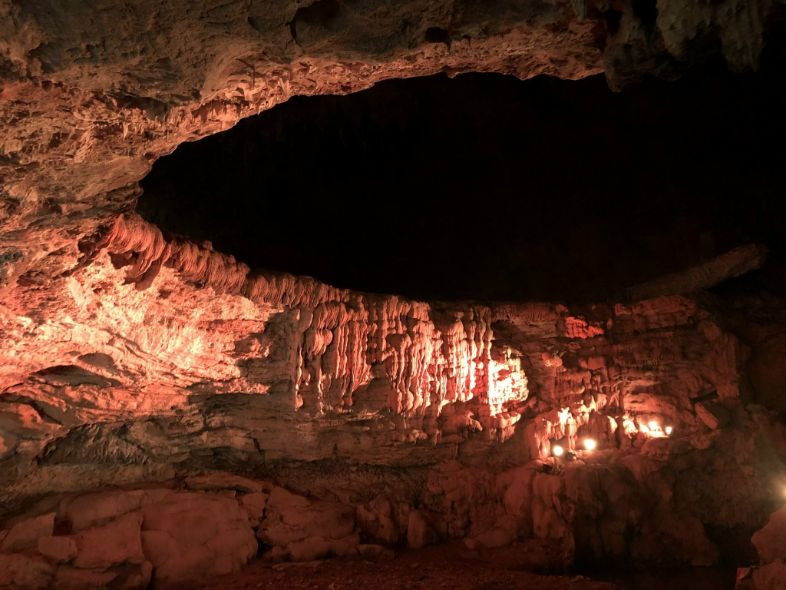 The Central Palace chamber inside Nguom Ngao Cave, featuring massive limestone columns and dramatic rock formations.